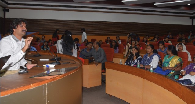 Santosh Talaghatti addressing a hall of students — the collaborative core of the Global Internship Program journey